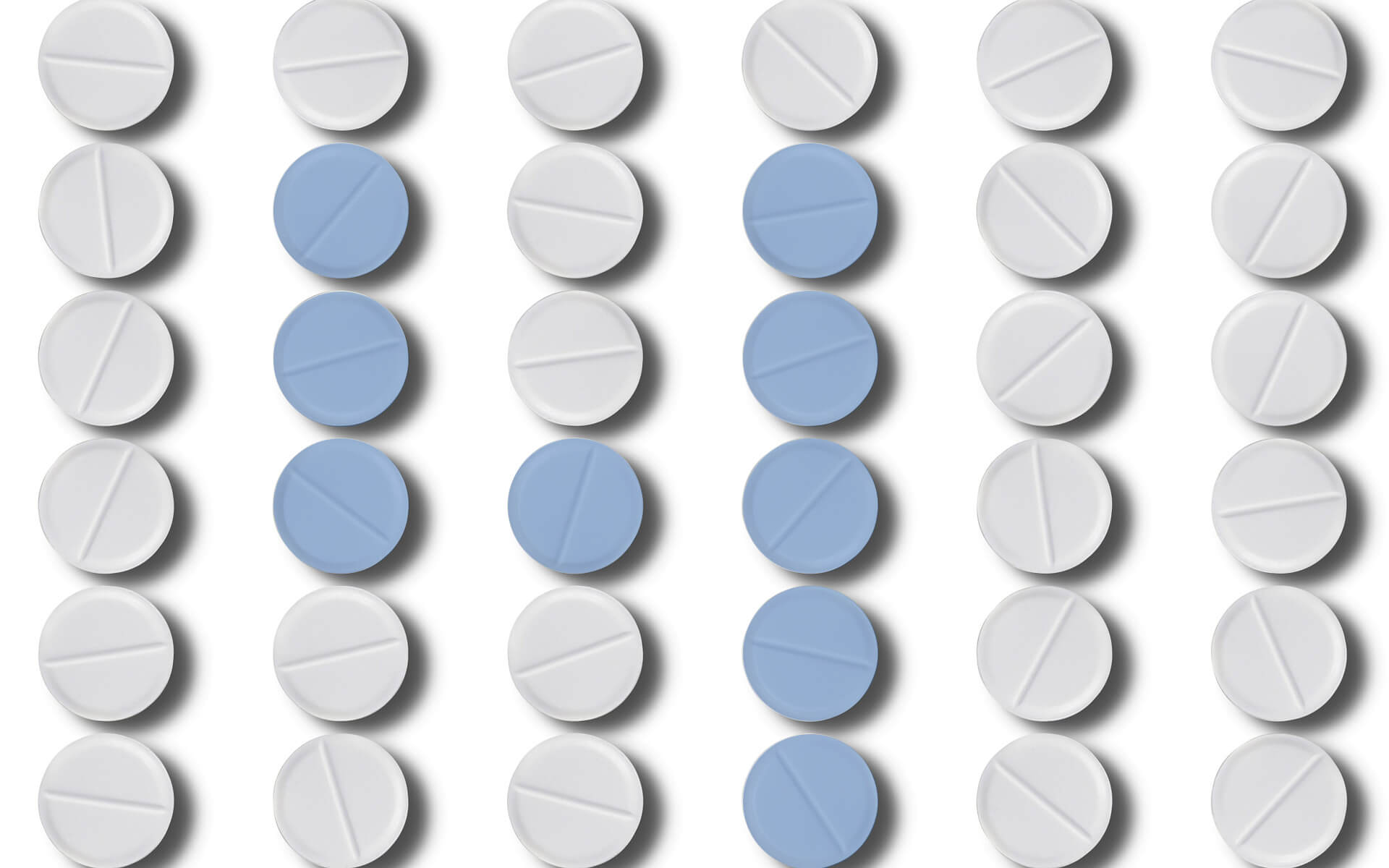 A bunch of pills are sitting in rows