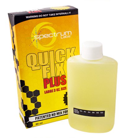 A bottle of liquid next to the box.