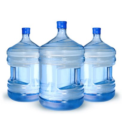 Three water jugs are lined up on a table.