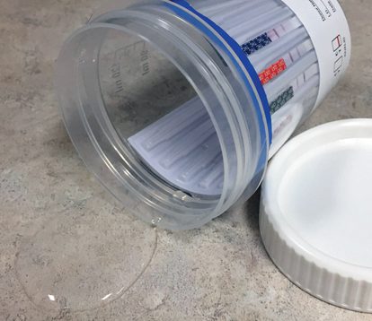 A jar of pills sitting on top of the floor.