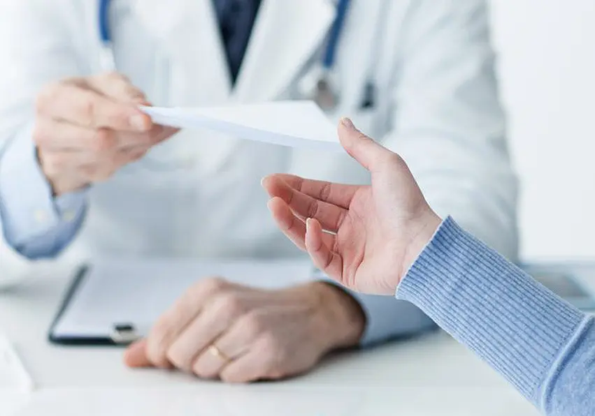 Doctor handing over a document