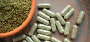 A bowl of powder and some pills on the table