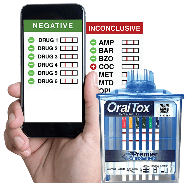 A hand holding an iphone next to a bottle of oral tox.