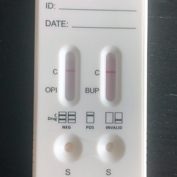 A white device with two buttons and a black background