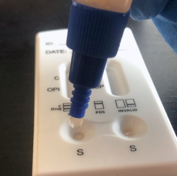 A blue marker is on top of a white box.