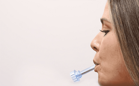 A woman with a toothbrush in her mouth.