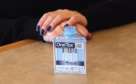 A person with their hands on top of the table.