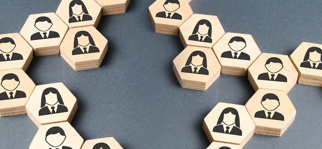 A table with wooden blocks that have people on them.