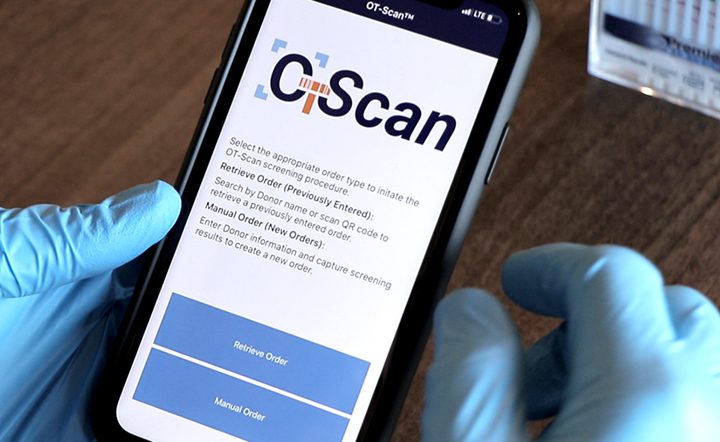A person is holding an iphone with the ci scan app open.