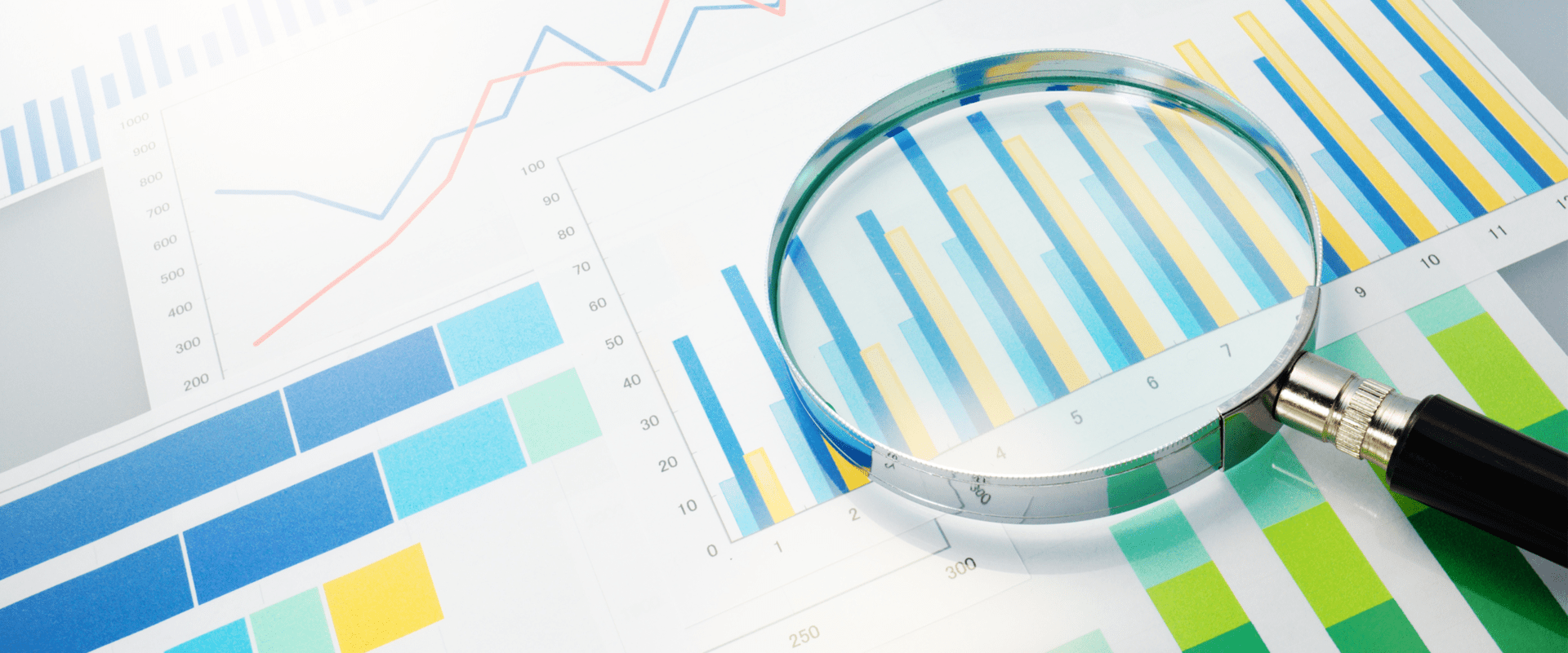 A magnifying glass sitting on top of a paper.