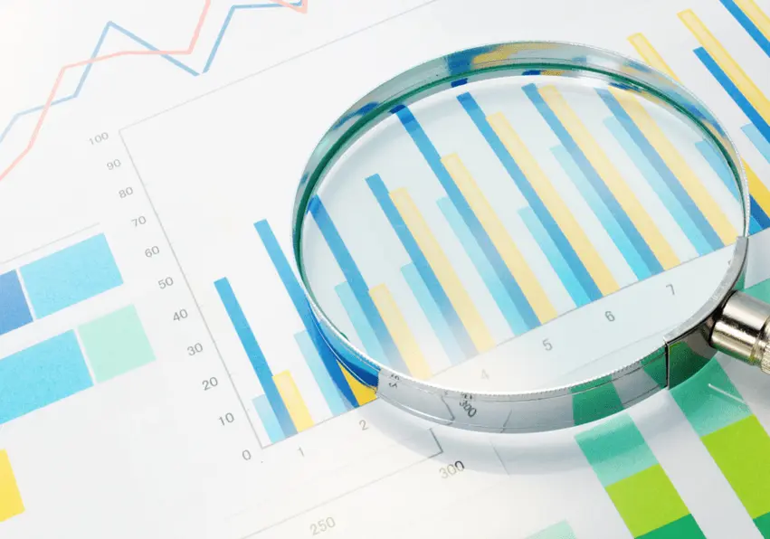 Magnifying glass on top of some charts