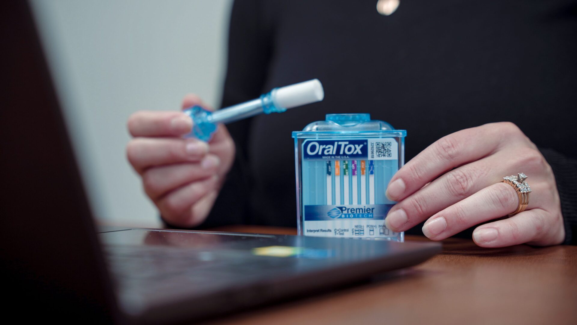 A person holding an oral-b toothbrush and toothpaste.