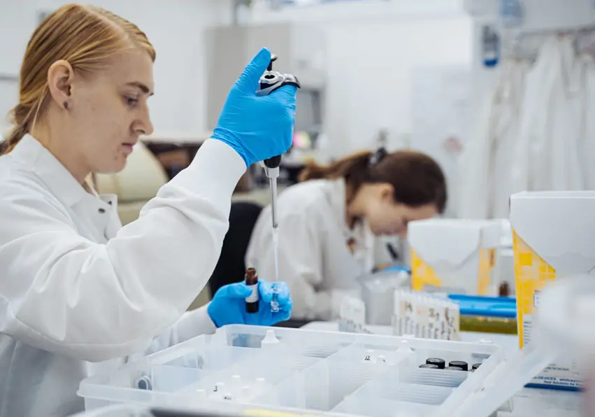 Scientist using tools for testing urine.