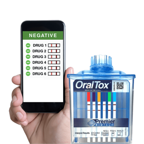 A person holding an iphone and a box of oral tox.